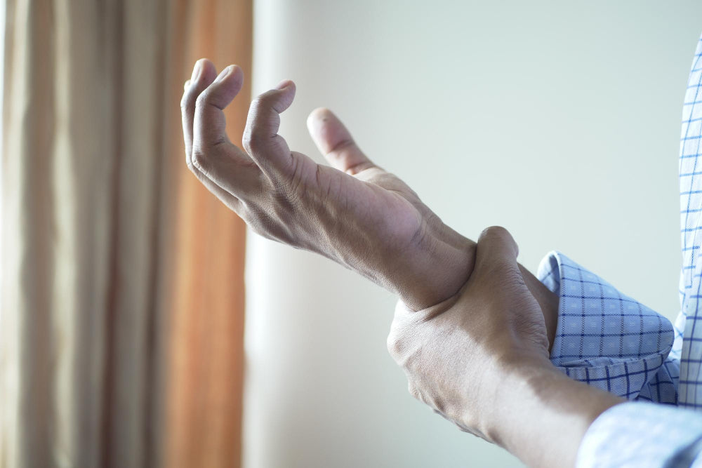 Parkinson's progression of a man's hand showing visible pain and stiffness.