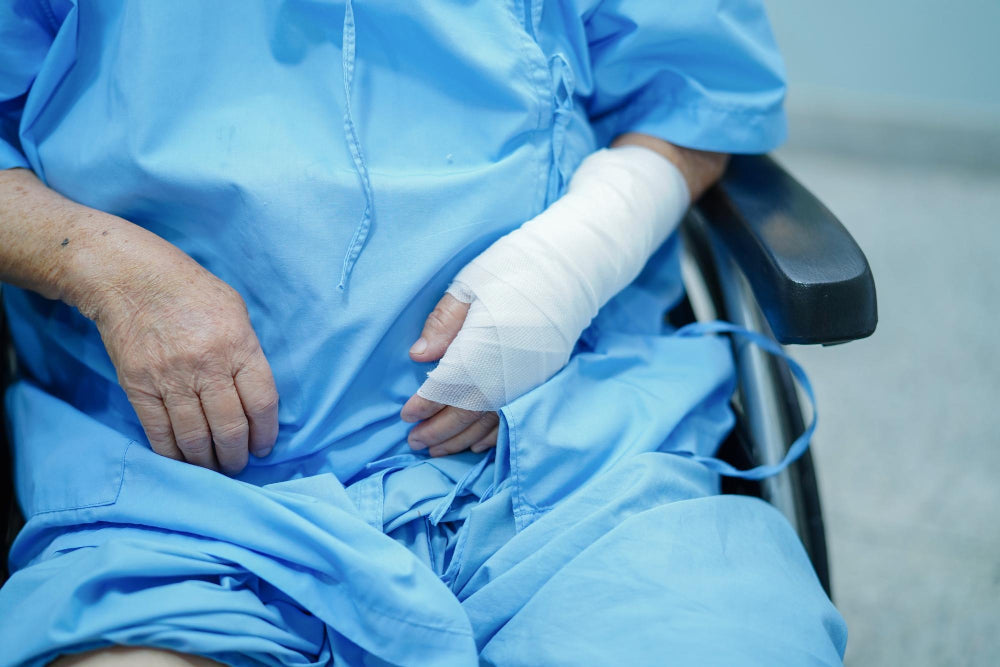 Deep brain stimulation recovery, where a senior woman is seated in a wheelchair inside a hospital.