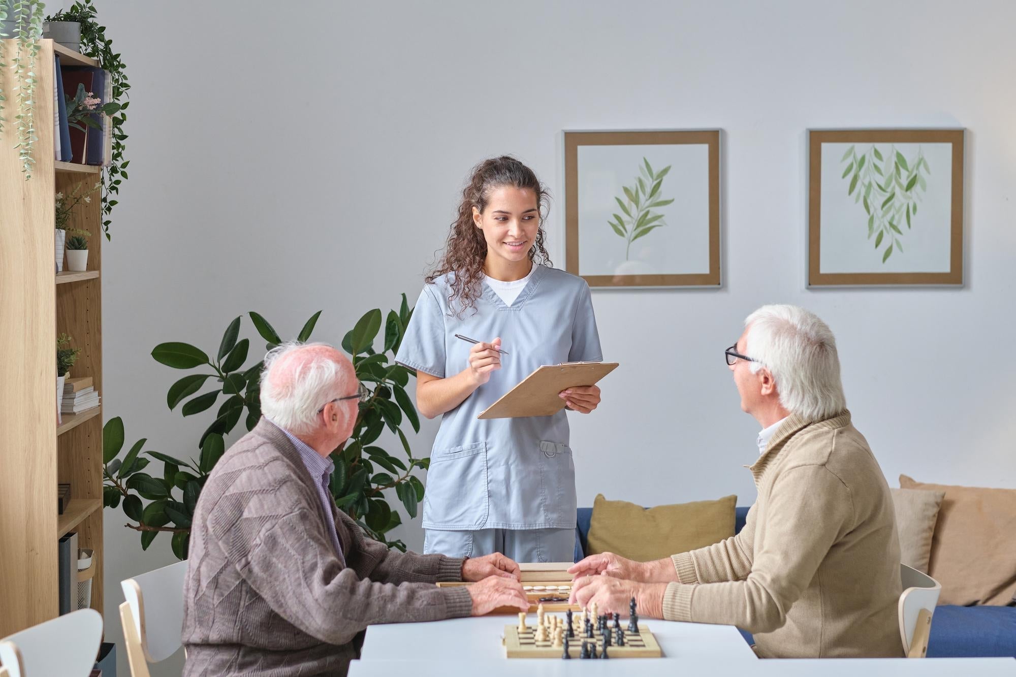 Older men playing chess, illustrating the early stages of Parkinson's Disease.