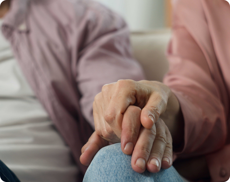 End-stage Parkinson's disease care, where an elderly couple holding hands expresses support and comfort 
