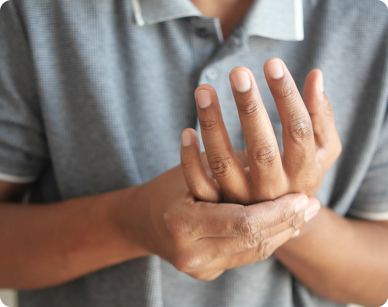A doctor guiding a patient through a coordination task as part of an essential tremor test during a neurological exam
